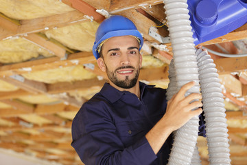 portrait of male worker installing air conditioning unit