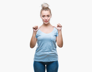 Young blonde woman over isolated background looking confident with smile on face, pointing oneself with fingers proud and happy.