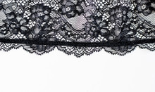 Black Lace Texture With Flowers On A White Background.Background Of Black Lace With A Flower Pattern On A White Background. Black Guipure. Black Fabric With An Ornament. 