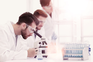 Wall Mural - background image scientists working with the microscope