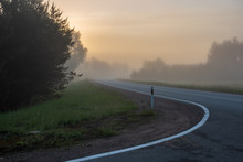 Empty Asphalt Road With White Lines Painted In Misty Morning