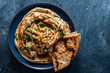 Classic Hummus with chickpeas, paprika, olive oil and oriental spices. Mediterranean popular snack of chickpeas and tahini pasta