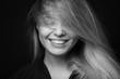 © Restyler - Black and white portrait of a beautiful smiling woman on a dark background