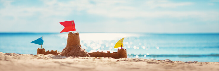 Fototapete - Sandcastle on the sea in summertime