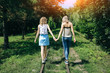 © Vadym - Two hipster girls are walking on the railway in the green park. Same sex couple is holding hands together. Travel style life concept. Support and friendship relationships.