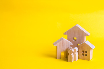 Wooden houses and people on a yellow background. The concept of buying home sales, rent. Construction and relocation. Adaptation in the new city. Investments and insurance. City authorities.