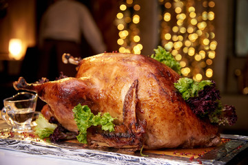 Appetizing baked turkey close-up on a background of bright bokeh.