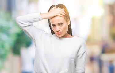 Poster - Young braided hair african american girl wearing winter sweater over isolated background confuse and wonder about question. Uncertain with doubt, thinking with hand on head. Pensive concept.