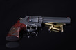 © Mark - gun and bullets on black background