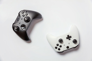 White and black two joystick gamepad, game console isolated on white background. Computer gaming technology play competition videogame control confrontation concept. Cyberspace symbol