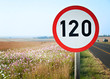 A speed sign of 120 Kilometer per hour, next to a road, overlooking a valley, in kwazulu natal, south africa