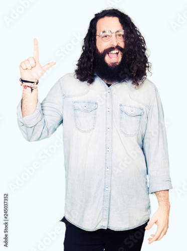 Young Hipster Man With Long Hair And Beard Wearing Glasses