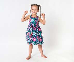 Little girl exercising dancing with arms lifted in celebration success