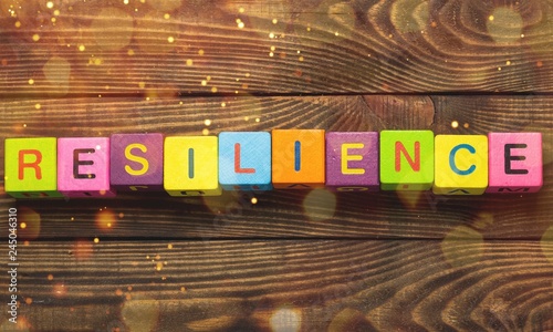 Fotomural Resilience sign with wooden cubes on background