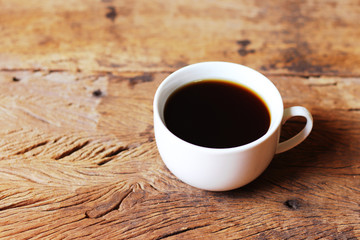 cup of coffee and beans on wooden table