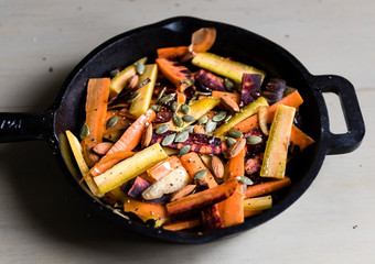 Wall Mural - Mixed carrots and turnips in a sauce pan