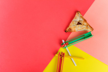 Purim background with party costume and hamantaschen cookies