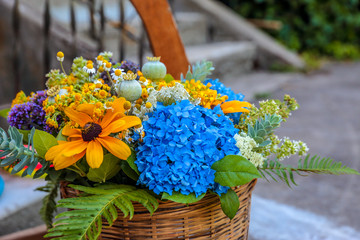 Wall Mural - A basket full of summer filed flowers
