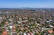 Aerial view of houses in the Melbourne suburb of Preston Victoria on a summers day. The city of Melbourne can be seen in the distance.