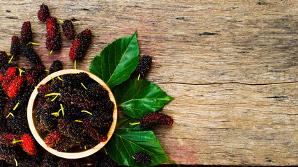 Wall Mural - Mulberries fruits in wooden bowl on wood backgrounds above