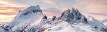 Panorama Of Steep Peak Mountains With Covered Snow And Mountaineer Man Backpacker