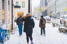 Person Walk In City Streets In Winter Season Under Snowfall B