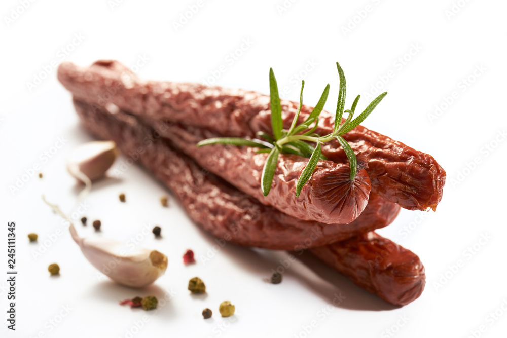 Sausage with herbs and spices on a white background - obrazy, fototapety, plakaty 