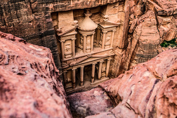 Spectacular view from above of Al Khazneh (The Treasury) in Petra during a sunny day. Petra is a historical and archaeological city in southern Jordan.