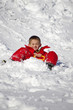 © minicel73 - vacances d'hiver - enfant en combinaison rouge faisant de la luge