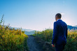 © exebiche - Young man in a business suit on the background of mountains goes to his aim on a sunny summer day