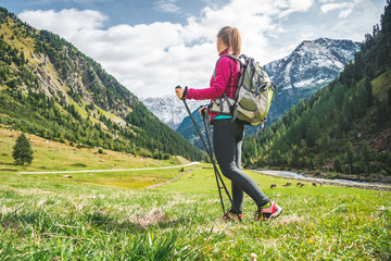 Wall Mural - young woman hiking in the mountains