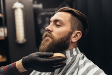 Hipster Young Good Looking Man Visiting Barber Shop. Trendy And Stylish Beard Styling And Cut.