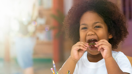 Little kid children smiling enjoy eating snack with happiness.