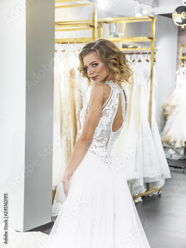Woman Choosing Wedding Dress In Shop Attractive Young Bride Is