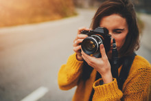 Young Female Photographer Taking Photograph On Vintage Camera Outdoors, Blank Space For Text Message Or Design, Tourist Girl Enjoying Road Trip In Europe, Flare Light