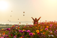 Lifestyle Traveler Women Raise Hand Feeling Good Relax And Happy Freedom And See The Fire Balloon Outdoors The Nature Tea And Cosmos Farm In The Sunrise Morning. Travel And Summer Concept