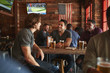 © Monkey Business - Group Of Male Friends Meeting And Drinking Beer In Sports Bar Together
