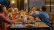 © Gorodenkoff - Group of Friends Gathered Together at the Table Relatives and Friends, Young and Elderly are Eating, Drinking, Passing Dishes, Joking and Having Fun. Garden Party Evening Celebration.