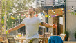 © Gorodenkoff - Handsome Fit Young Man Enjoys Summer Under the Rain Made by Garden Water Hose Sprinkler, Raises Arms. Muscular Guy Cools on a Hot Summer Day.
