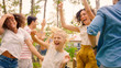 © Gorodenkoff - Family and Friends Dancing together at the Garden Party Celebration. Young and Elderly People Having Fun on a Sunny Summer Day Disco.