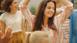 © Gorodenkoff - Beautiful Brunette Dances Together with Family and Friends at the Garden Party Celebration. Young and Elderly People Having Fun on a Sunny Summer Day Disco.