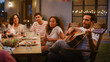 © Gorodenkoff - Sitting at the Dinner Table Handsome Young Man Plays the Guitar For a Friends. Group of Young People Listening to Music at the Summer Evening Garden Party Celebration.