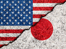 Concept Of Relations Between Japan And The United States Of America Symbolized Flags Painted On A Cracked Wall