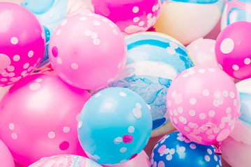 Colorful balloons on pastel color background. Festive or birthday party concept. Flat lay, top view.