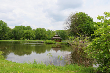 Wall Mural - midwest nature background with city park view. beautiful late spring cloudscape with trees around th
