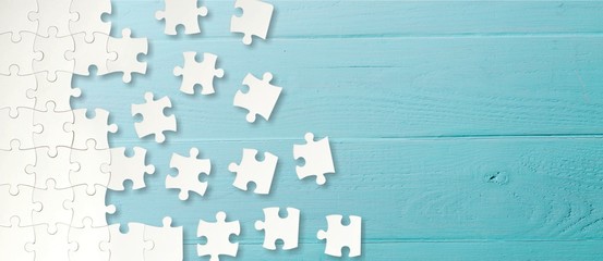white puzzle pieces on blue background