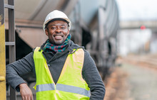 Portrait Of A Smiling And Satisfied African American Engineer Wearing Protective Workwear Posing On Construction Site