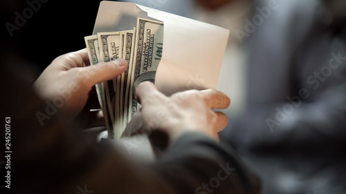 Cuadros en Lienzo Envelope with dollars, lady giving bribe to politician to cover illegal business