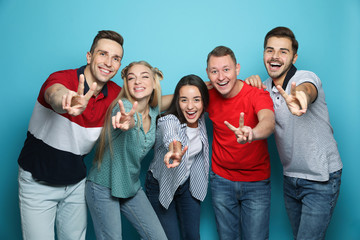 Poster - Group of friends laughing together against color background