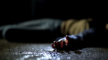 Close-up Bloody Body Of Young Woman Lying On Ground, Terrible Killing, Robbery